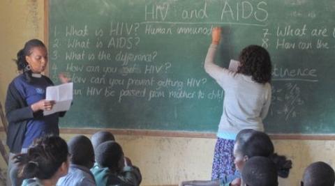 Yvonne and Charlee teaching about HIV in a classroom