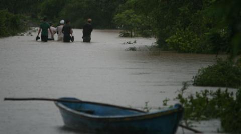 People walking through flood in El Salvador