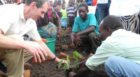 Mark plants a tree at Chembe village Forest Club, Malawi
