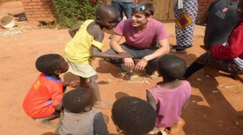 One of the UK ICS volunteers interacting with local children 