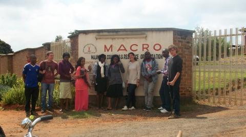 Volunteers standing outside the Malawi AIDS Counselling & Resource Organisation