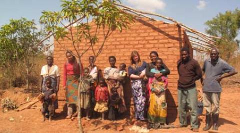 Rose Kumwenda (third right) and family in front of her newly built house constru