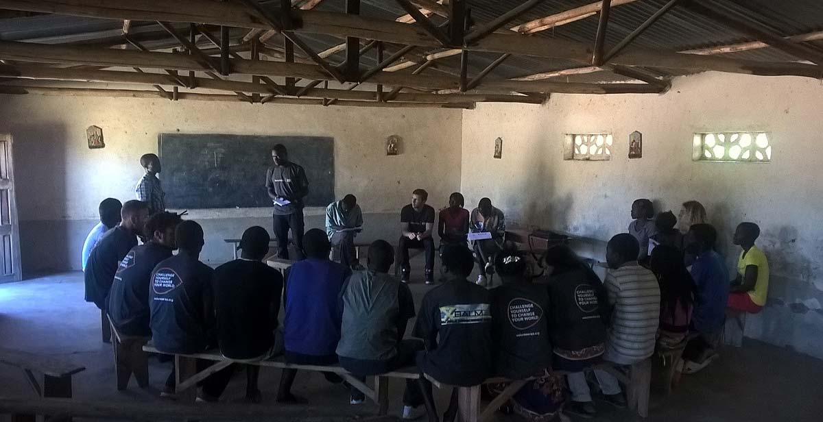 Team member Patrick addressing Chasato Youth Club leaders and members and translating English and Chitumbuka