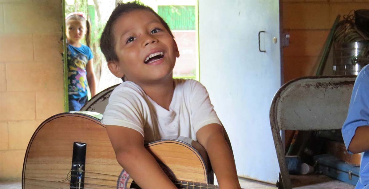 Local boy playing a guitar