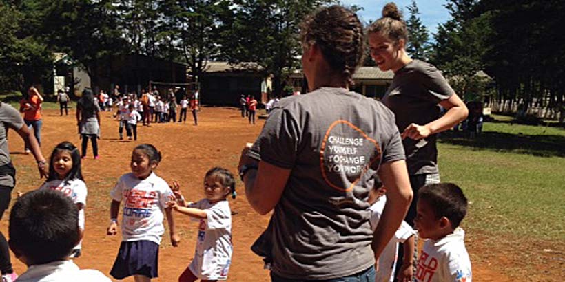 Volunteers with children from the local school during an event