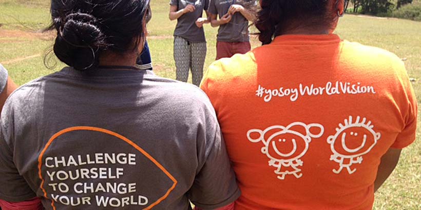 Volunteers showing their Progressio ICS and World Vision t-shirts